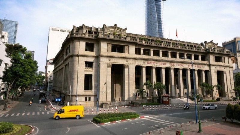 DHL Express employee receiving a parcel for shipping during holiday season