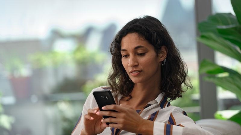 a business owner handling negative eBay feedback on her mobile phone