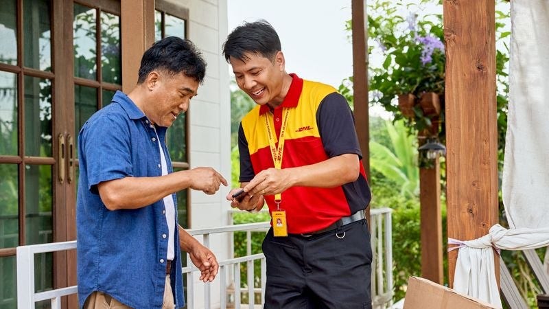 a customer receiving a package through dhl express’s shipping services