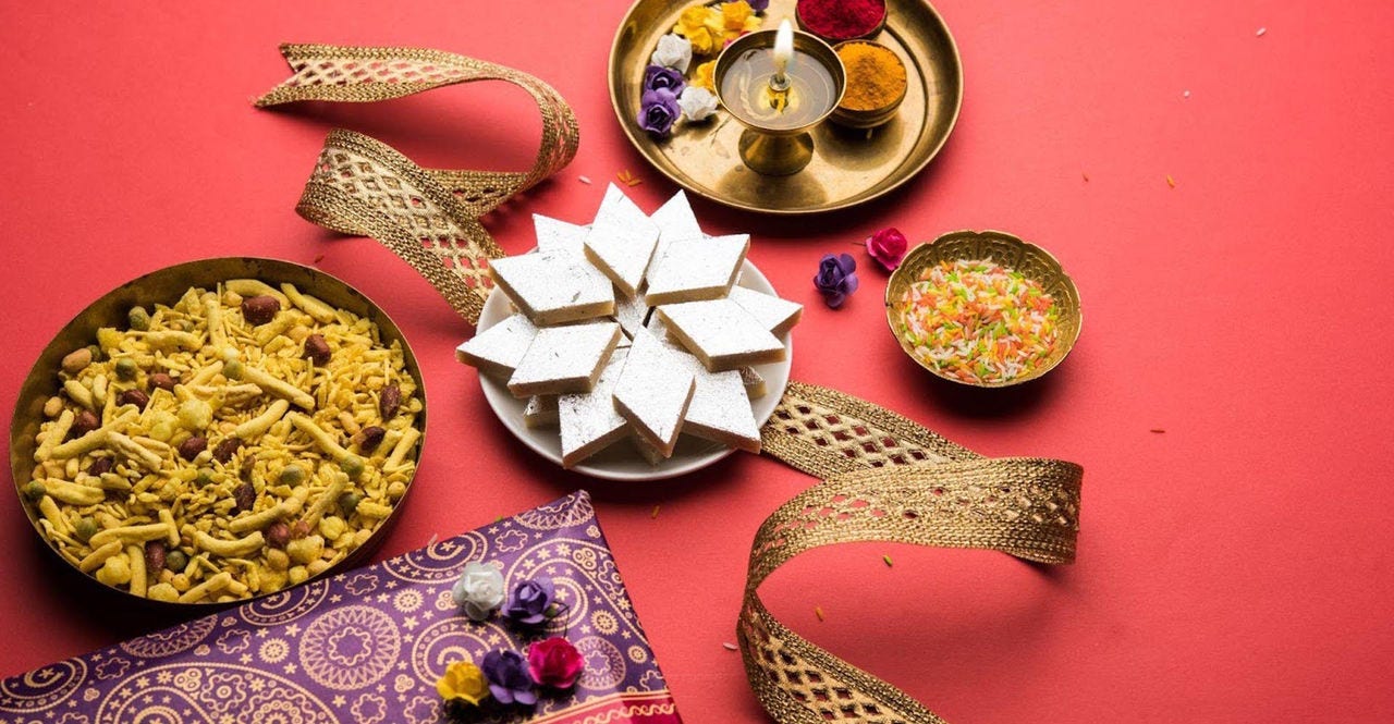 an assortment of indian festive gifts on a red background