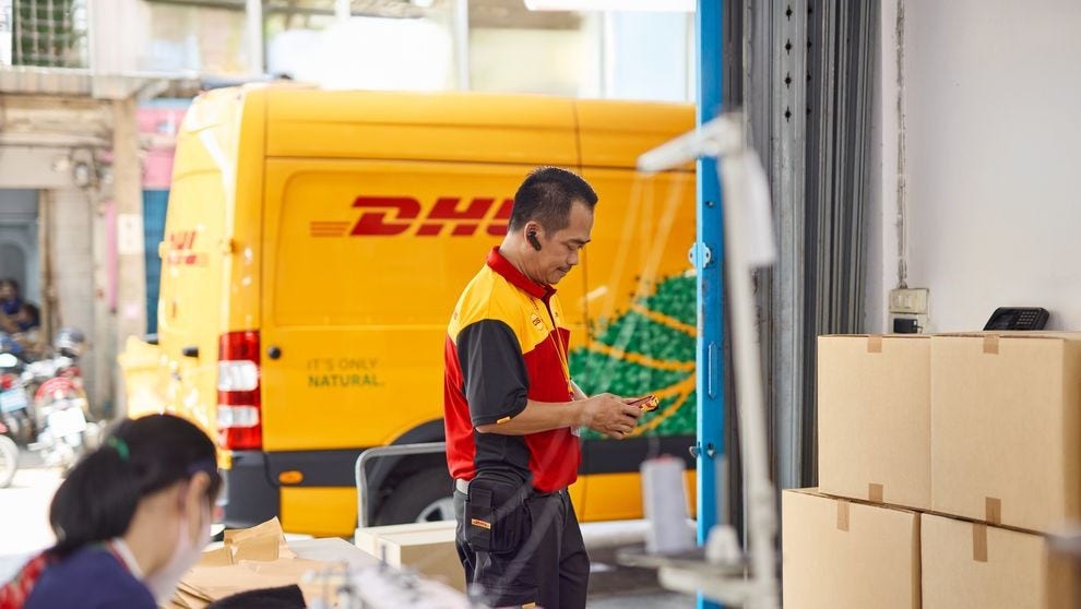 DHL Employee loading up textiles from the Philippines to be delivered to businesses in the US
