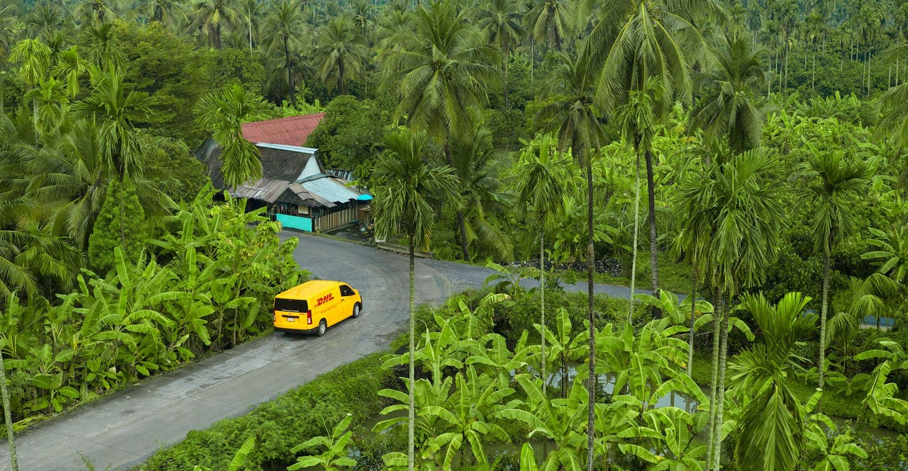 dhl express vehicle en route to collect a coffee shipment