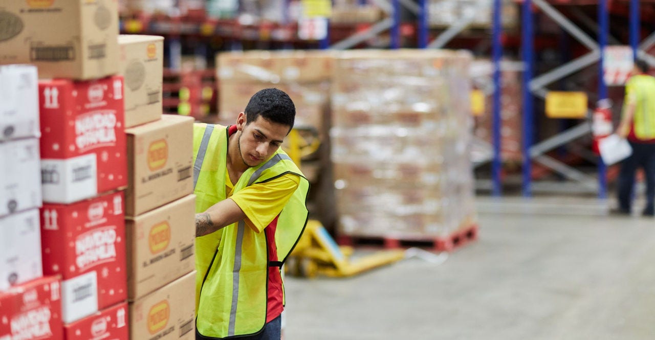 dhl express employee moving packaging for transport