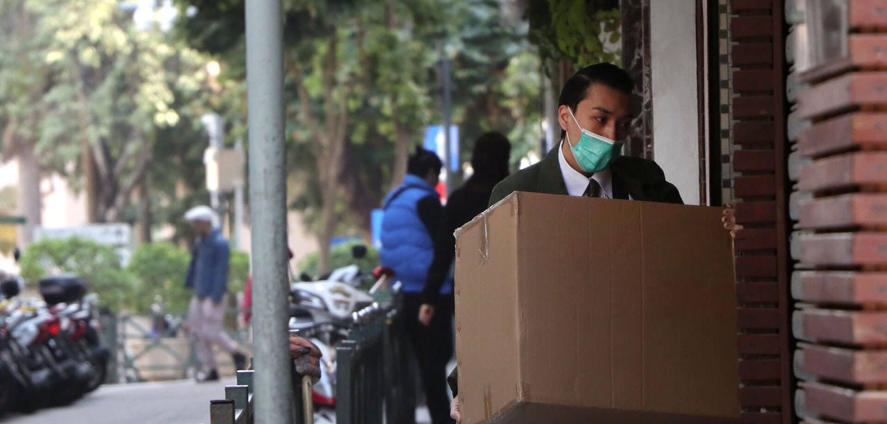 man in mask delivering box