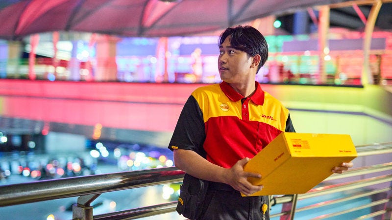 dhl express courier holding on to a parcel for delivery