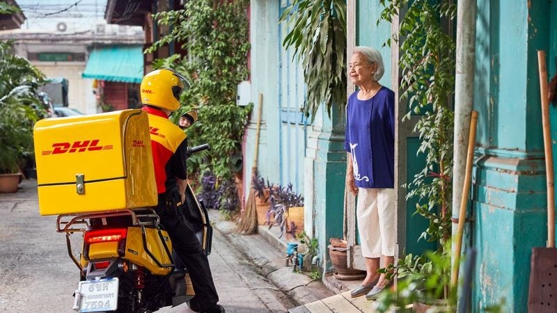 dhl express employee handling package to the recipient in the philippines