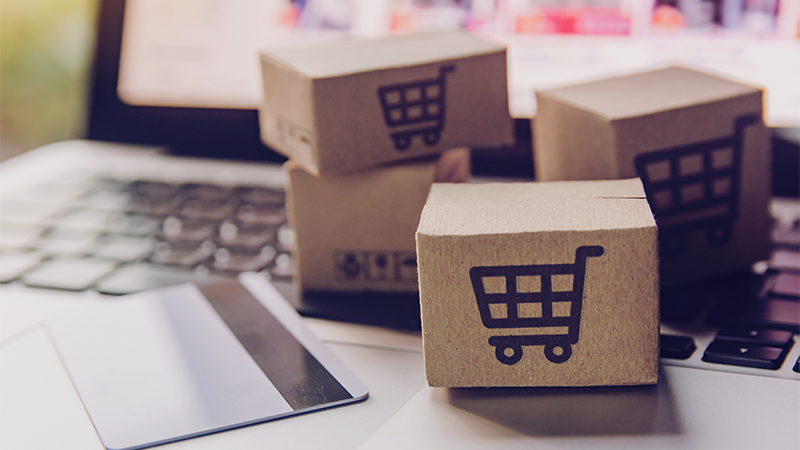 E-commerce Advice hand typing on laptop + boosting online sales ecommerce