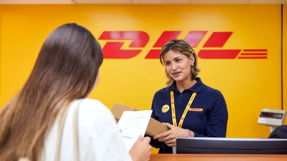 Lady dropping off a package at a DHL service point