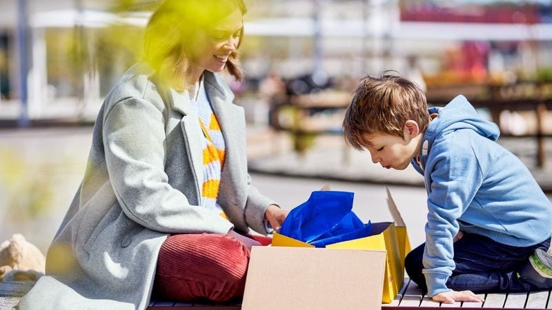 A mother and child open their DHL Express parcel.