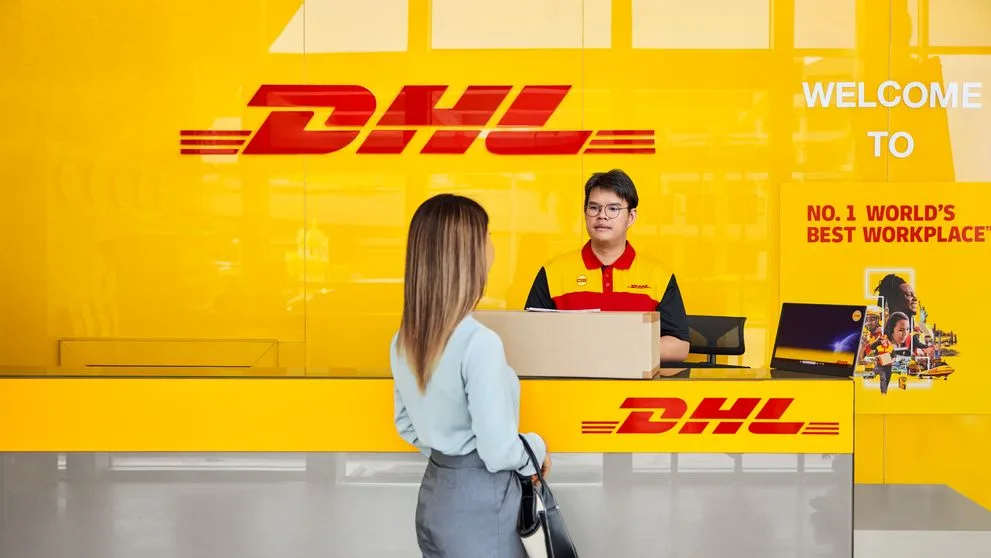 lady at a dhl service point sending a package to south korea
