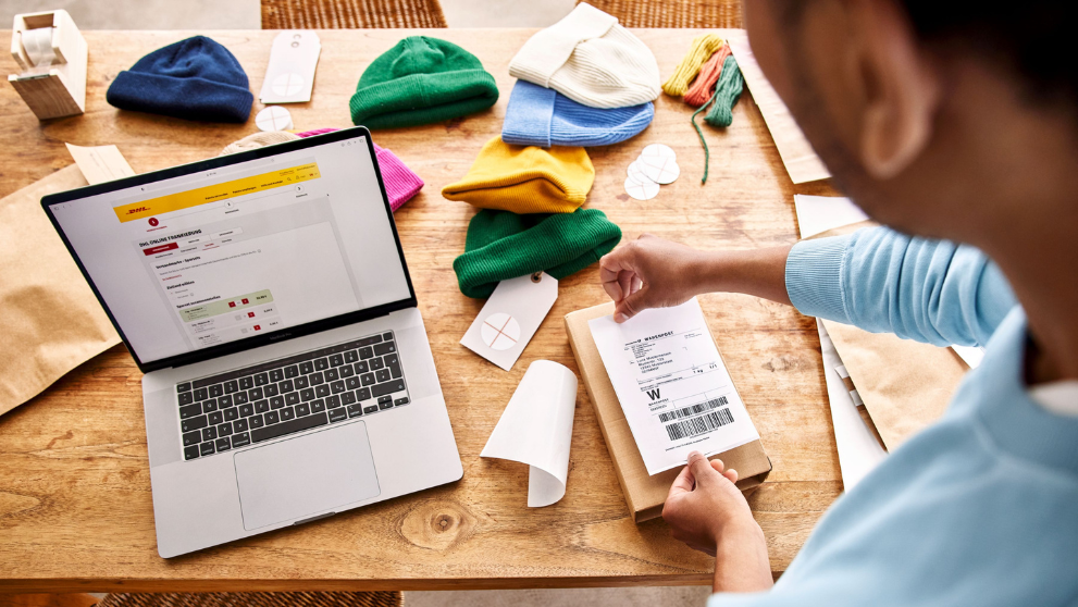 a man preparing his shipping request and packing his shipment
