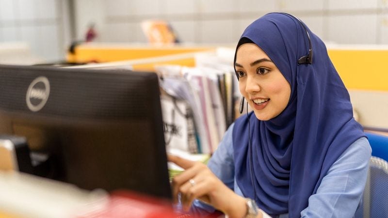 muslim dhl employee at her desk