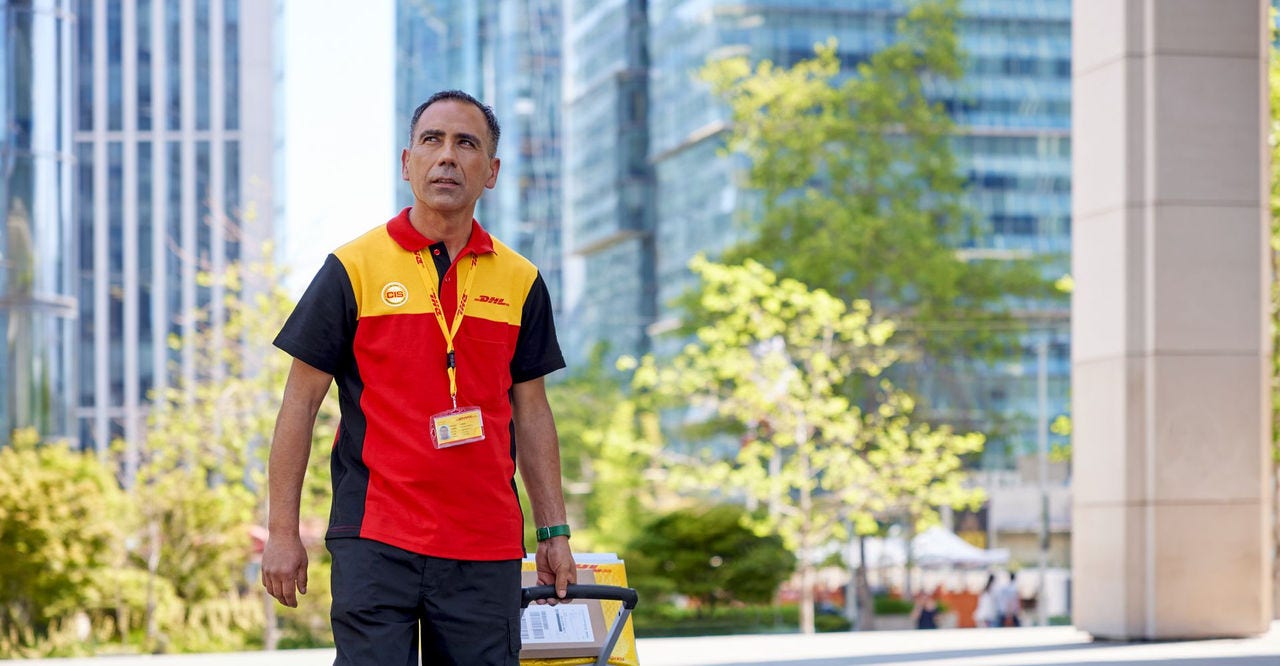 dhl express employee delivering packages to a location in qatar