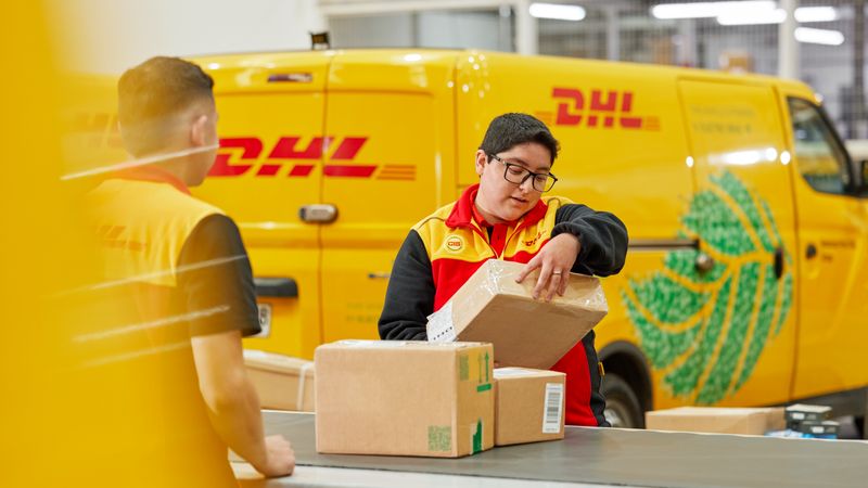 dhl express employee sorting out parcels