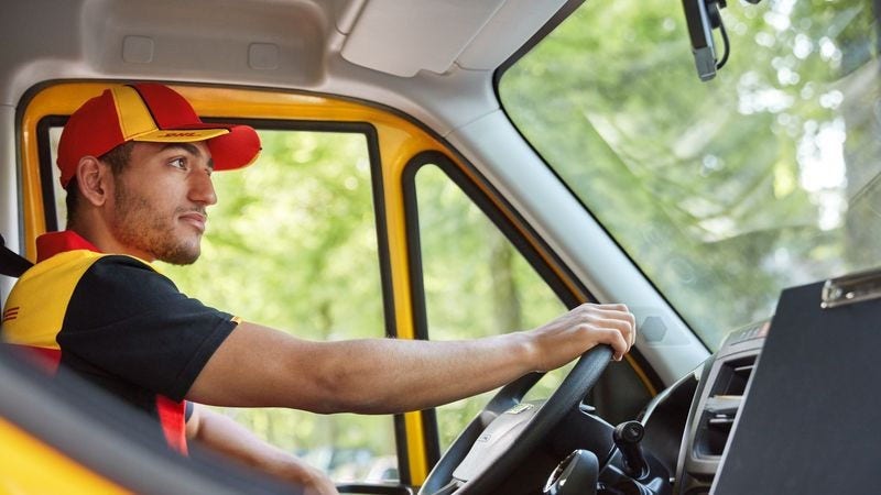 dhl staff delivering shipment in an eco-friendly electric van