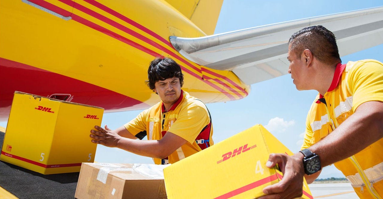 DHL staff sending packages into DHL’s cargo plane