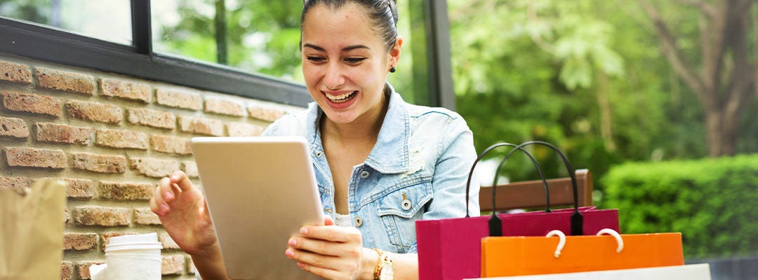woman smiling at tablet screen