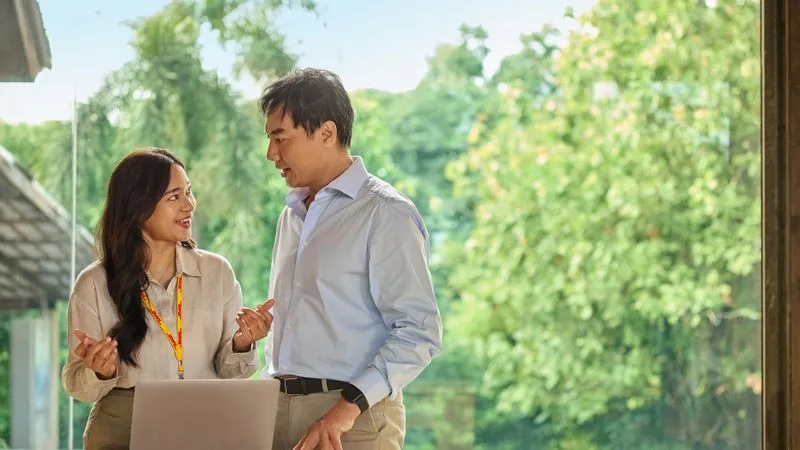 DHL Express employee advises a client on the documentation required for king coconut exports