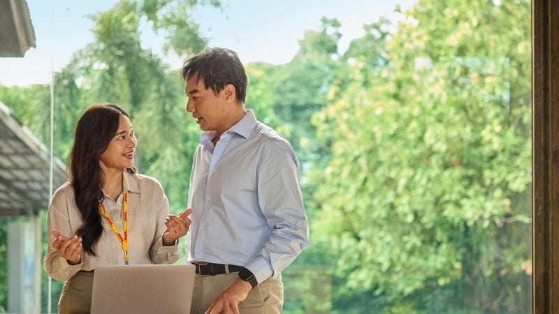 DHL Express employee advises a client on the documentation required for king coconut exports