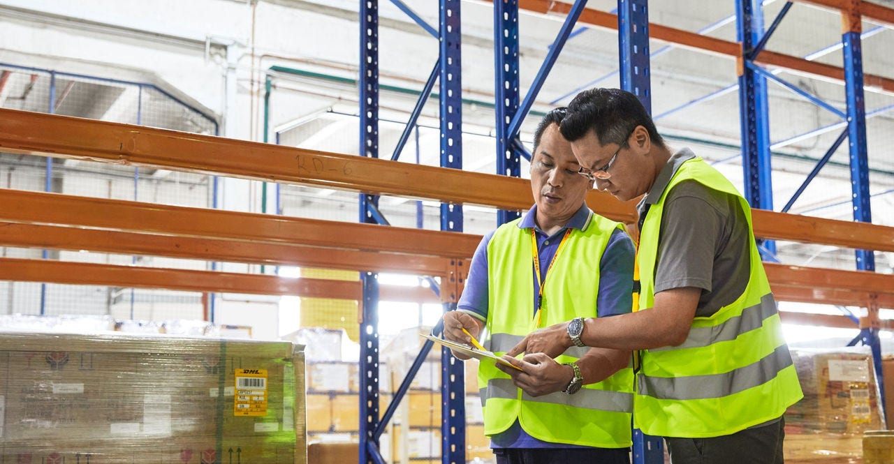 warehouse staff processing reverse logistics arrivals for returns management