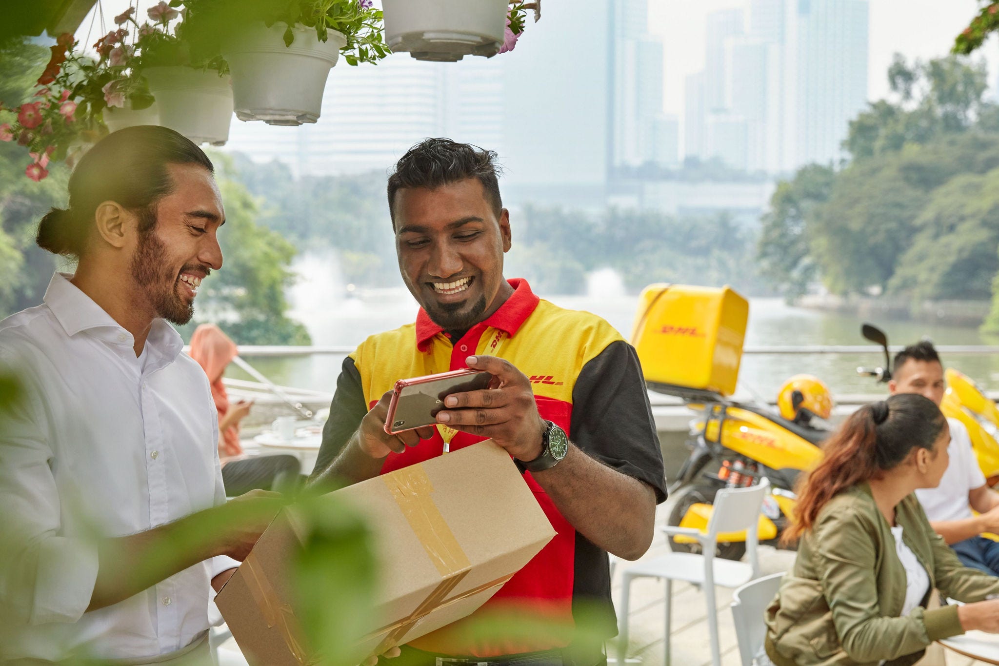 DHL carrier showing smartphone.