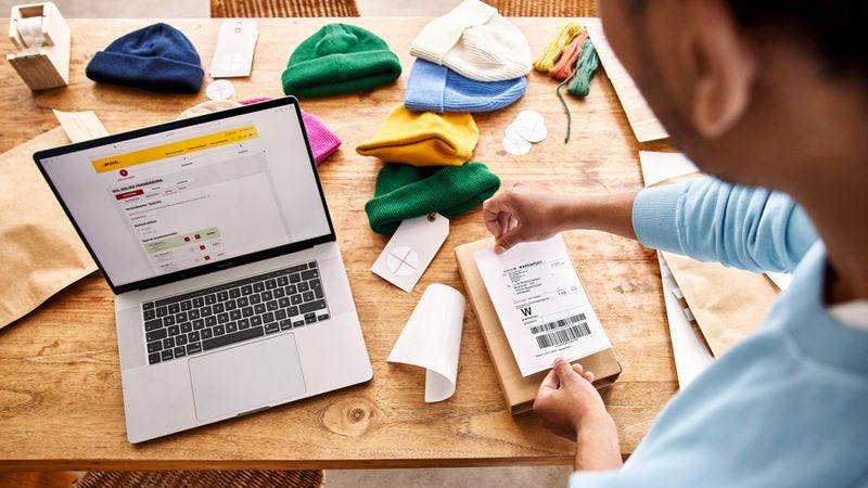 business owner labeling a packaging to be shipped