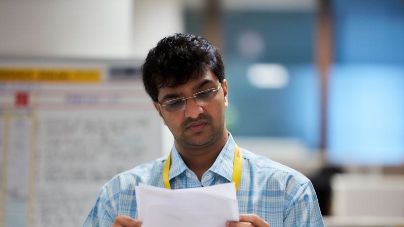 A male DHL employee overseeing the export documentation process.