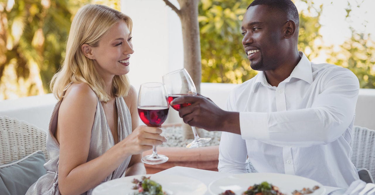 Romantic couple toasting their wine glasses in restaurant