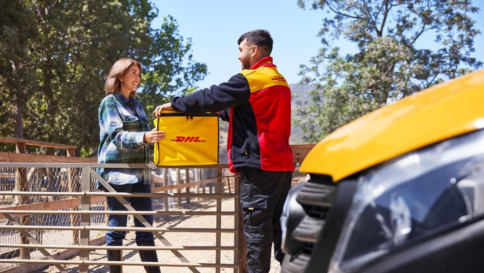 dhl employee delivering parcel with a reusable dhl cooling box