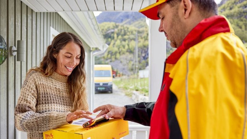 Woman receiving a package shipped globally by DHL Express