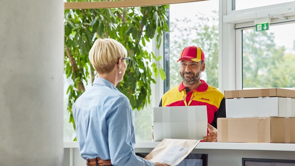 Australian fashion designer receiving a package from a DHL employee