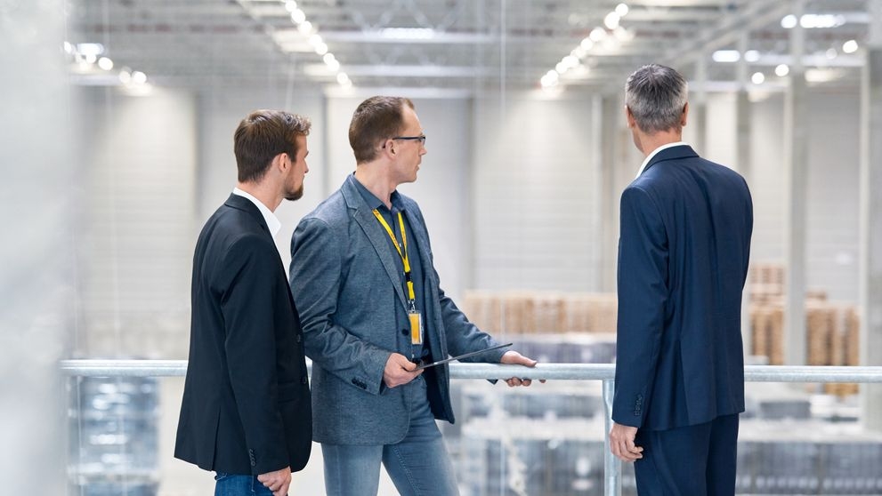 businessmen overlooking their production line