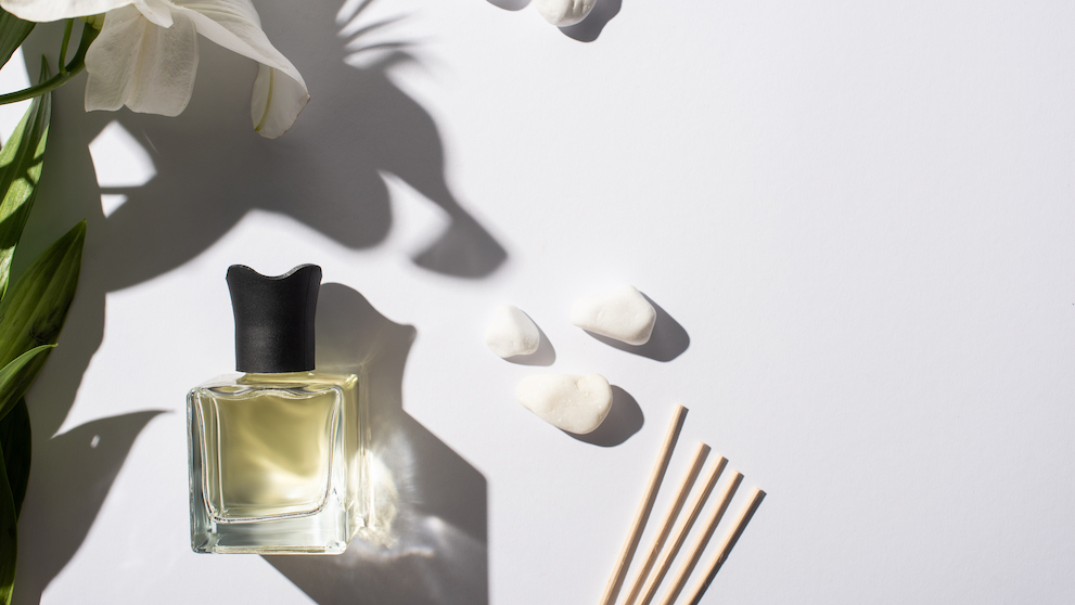 Top View of Aroma Sticks With Perfume in Bottle Near Stones And Lily Flower on White Background