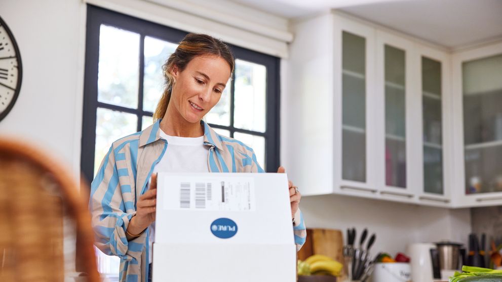 woman unboxing a parcel during Peak Season 