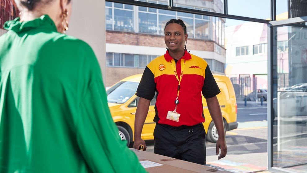 DHL delivery man greets store owner