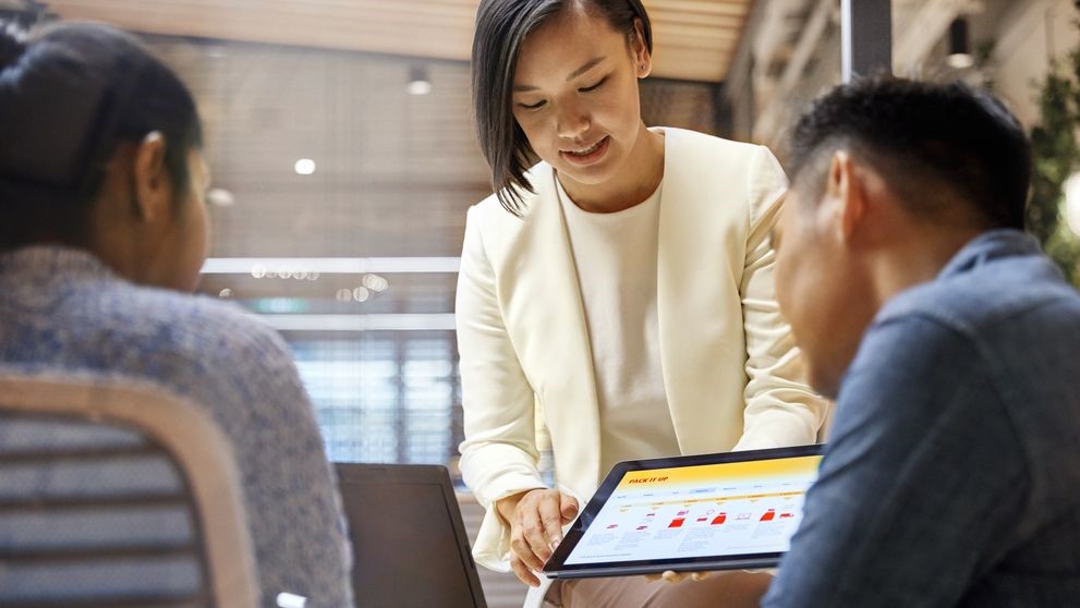 dhl express employee showing the role of ai in e-commerce to business owners