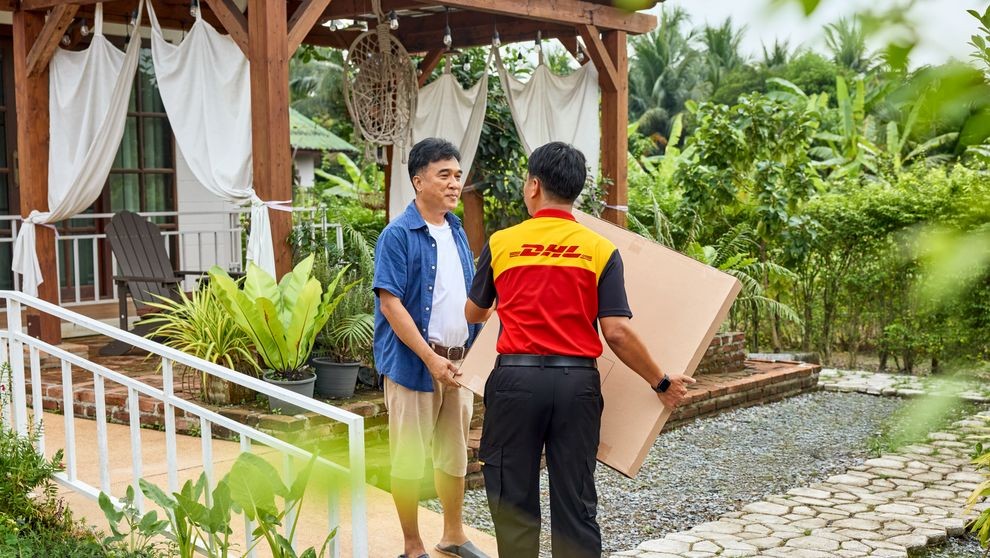 dhl express employee picking up a parcel for shipping from Cambodia