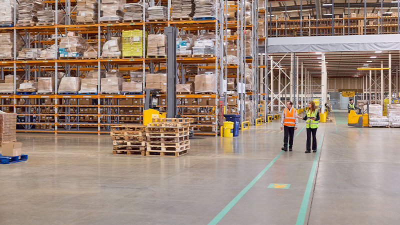 man and woman in a large warehouse