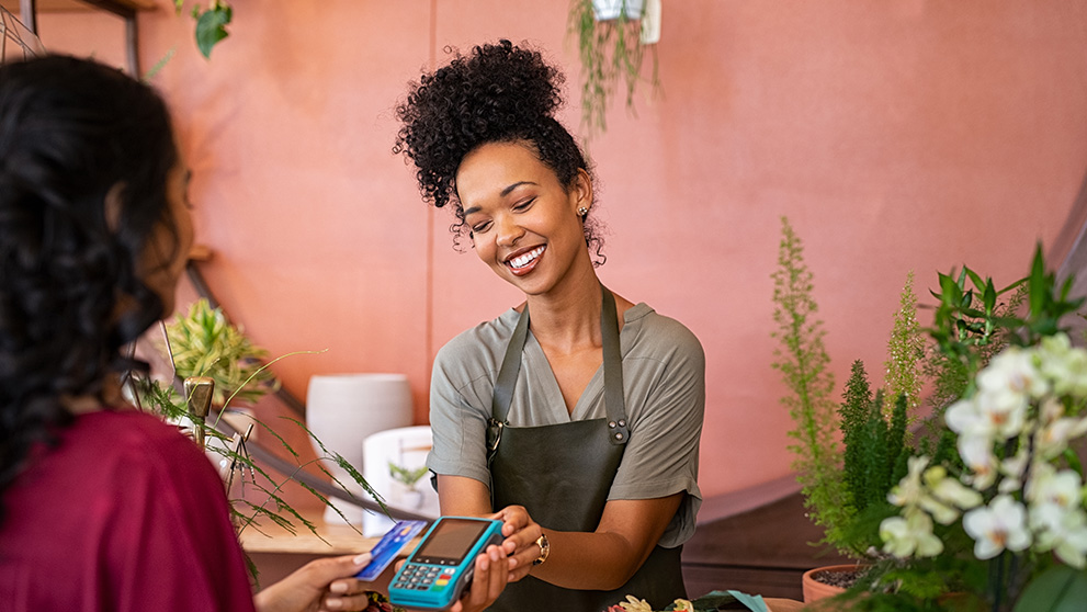 woman holding out payment device
