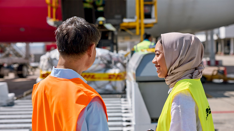 man and woman in hi vis on a tarmac