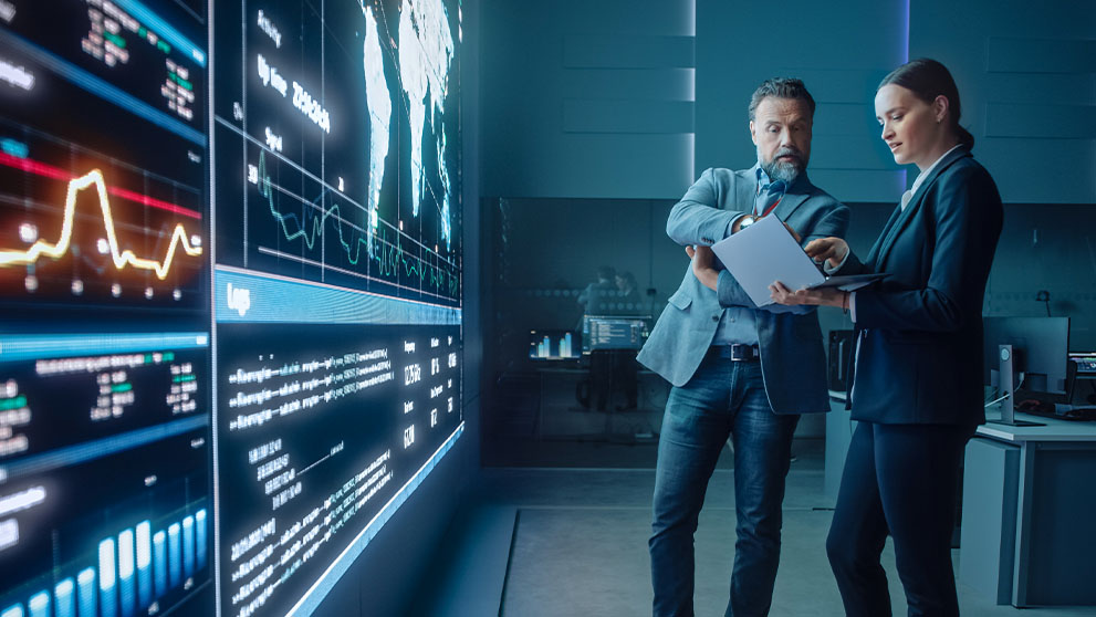 man and woman looking at laptop screen