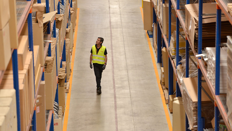 man in hi vis in a warehouse
