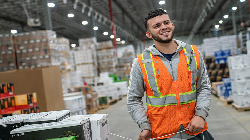 young man smiling in a warehouse