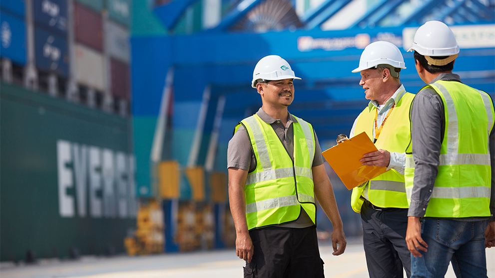 three men in hard hats talking