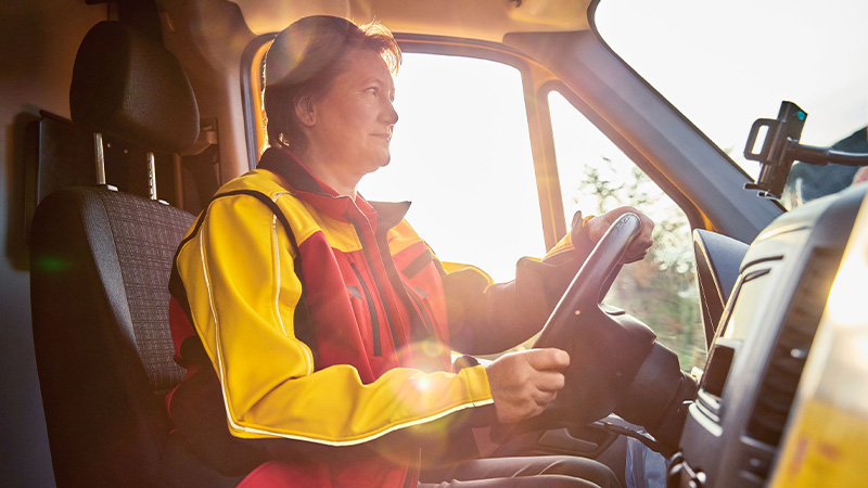 DHL lady courier sitting in a van