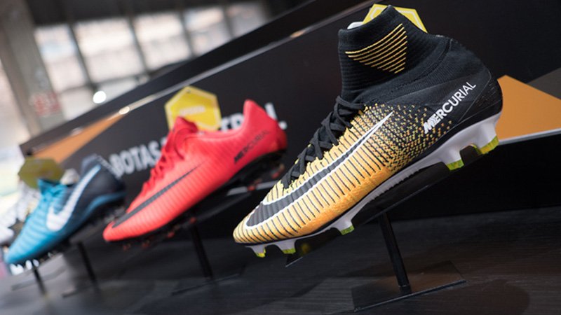 Three football boots on display