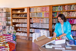 a shop owner is using cardboard boxes for packaging