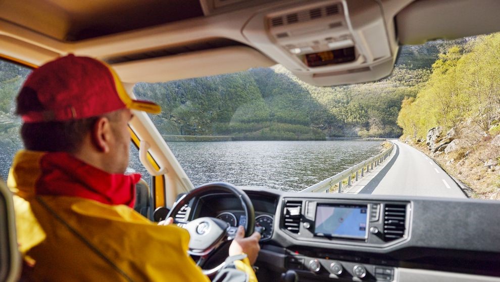 DHL delivery man delivering goods to India