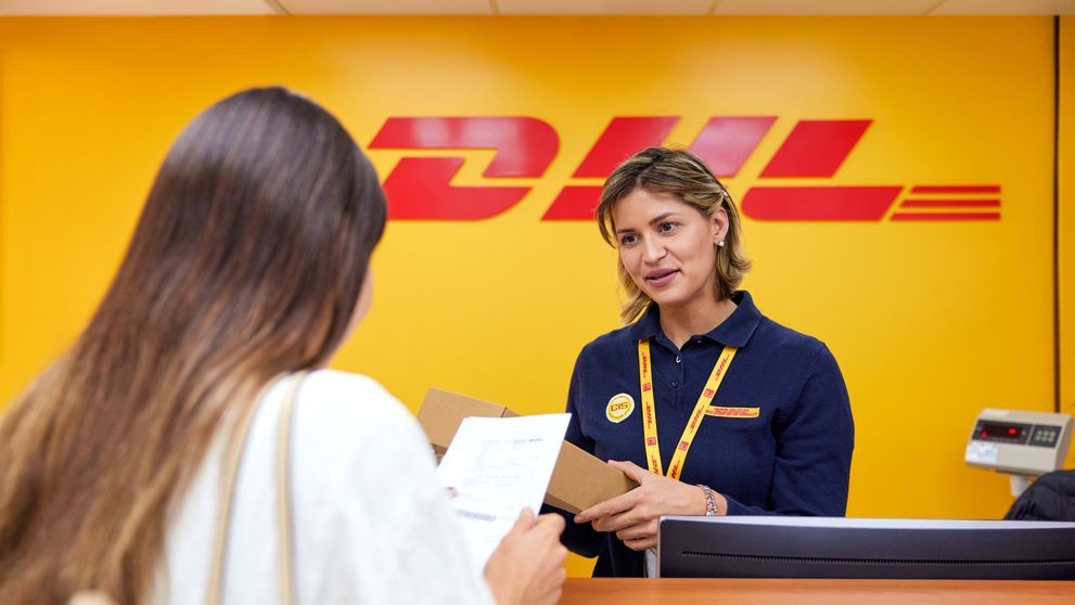 Lady dropping off a package at a DHL service point