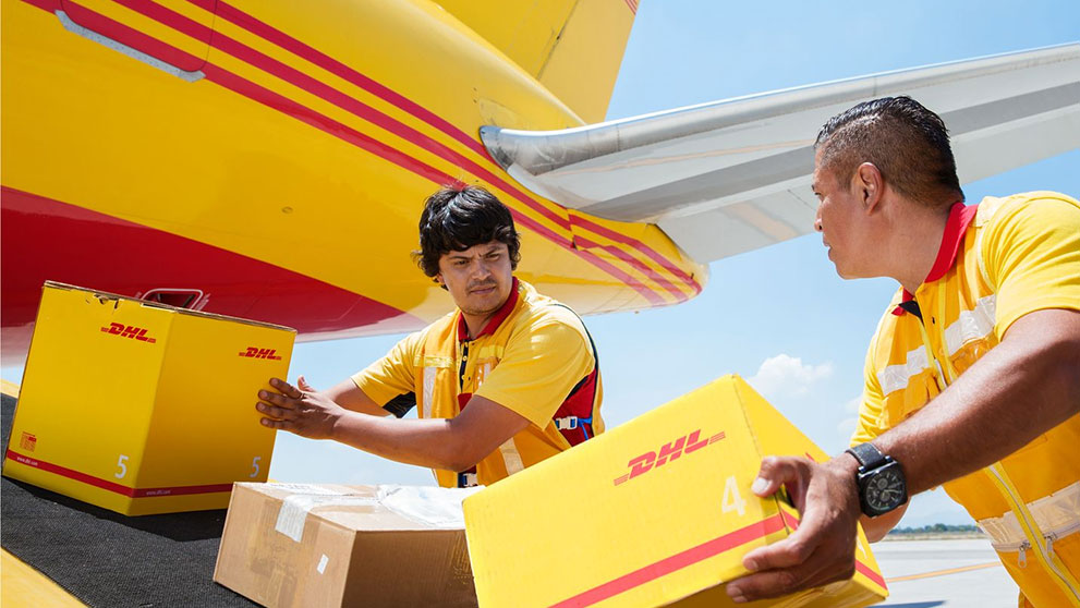 DHL staff sending packages into DHL’s cargo